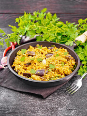 Bulgur with eggplant in pan on table