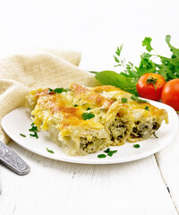 Cannelloni with curd and spinach in plate on table