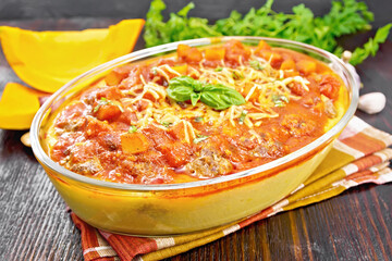 Porridge corn with meat and vegetables in roaster on board