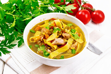 Soup with mung and noodles in bowl on board