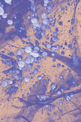 Abstract background of air bubbles in the frozen lake. Trendy color of 2022.