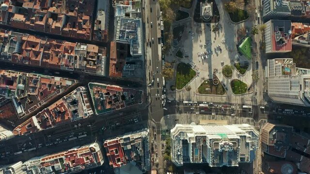 Aerial birds eye overhead top down view of traffic in streets around Plaza de Espana. Rooftop view of buildings in town.