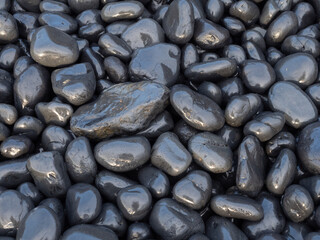 Smooth, Wet, and Shiny Black Stones From Above