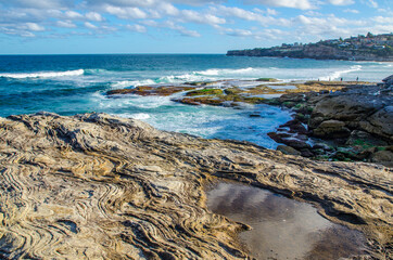 Natural Waves pattern on stone surface with ocean rocky beach view at Bondi bay, Sydney, Australia.