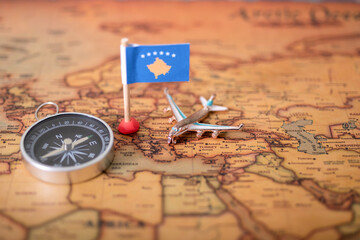 Flag of the Republic of Kosovo, compass and airplane on the world map.