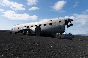 Impressive view of the Sólheimasandur Plane Wreck, the Remains of a 1973 U.S. Navy DC plane that crashed on black sand beach in Iceland