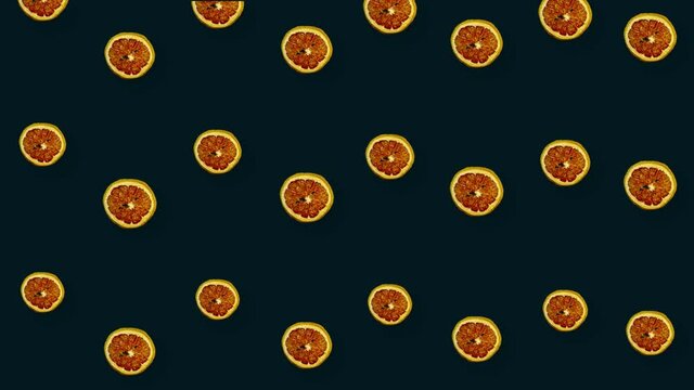 Colorful pattern of dried grapefruit slices on black background. Seamless pattern with dried grapefruit chips. Realistic animation. 4K video motion