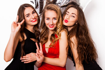 Three best friends celebrate  birthday indoor wearing elegant evening dress and have bright make...