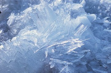 Blocks of river ice in spring. Fast melting. Ice texture on a spring day under the sun. Amur river. Ice needles.