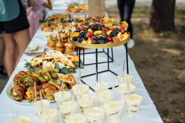 Wedding cake table background. Sweet and delicious restaurant desserts. Tasty food on buffet party.