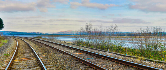 Railway tracks  on the bank of the Loughor River near Llangennech, South Wales, U.K.