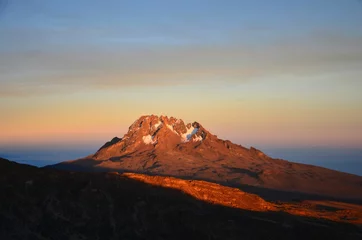 Photo sur Plexiglas Kilimandjaro Mount Mawenzi gleams in the last rays of the sun. sunset at kilimanjaro. Trekking on the highest mountain in Africa