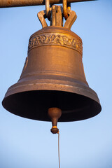 Large Church bell hanging outside. Close-up view of metal orthodox church bell