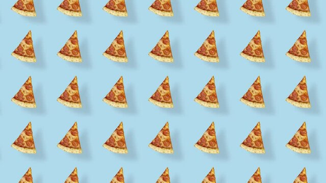 Colorful pattern of pizza isolated on blue background with shadows. Seamless pattern with pizza slices. Top view. Realistic animation. 4K video motion