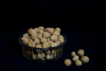 Stock photo of mini soya chunks kept in the glass bowl on dark black color background. at Bangalore, Karnataka, India. vegan food, coarse soya protein also known as soya meat.