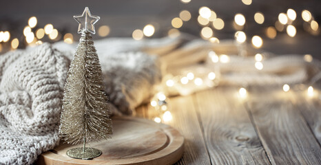 Decorative Christmas tree on blurred background with bokeh.