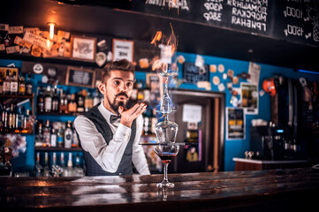 Barman mixes a cocktail on the beerhouse