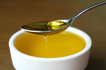 Natural olive oil in a spoon