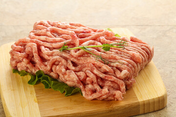 Raw minced pork meat over board