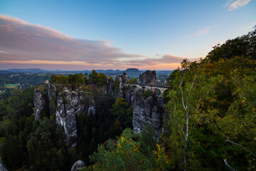 Fototapeta premium Bridge Bastei In Saxon Switzerland Germany utumn With Colored Trees sunset