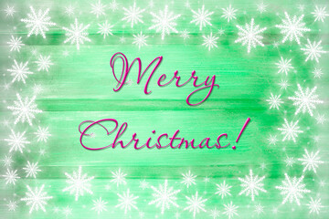 Winter wooden green nature background with snowflakes around. Texture of painted wood horizontal boards. Merry Christmas card.