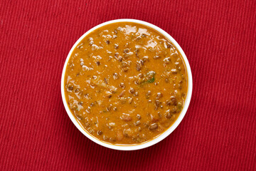 Top View of Dal Makhani in Bowl over cotton placemat