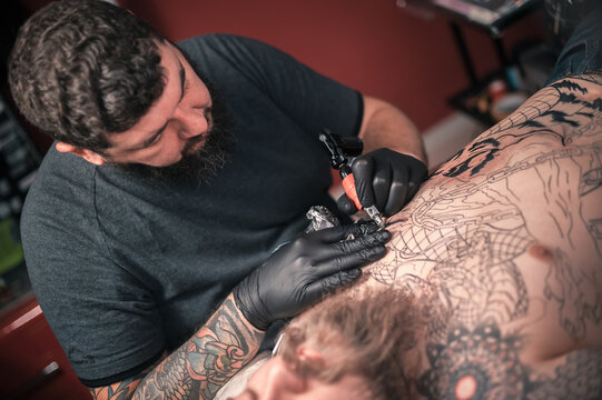 Tattoo artist demonstrates the process of getting tattoo tattoo studio
