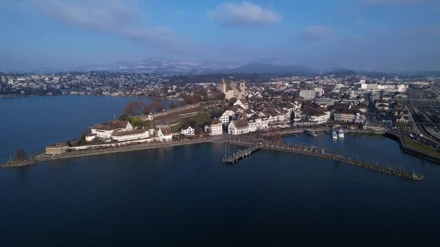 Beautiful skyline of old town Rapperswil and medieval castle, aerial orbit