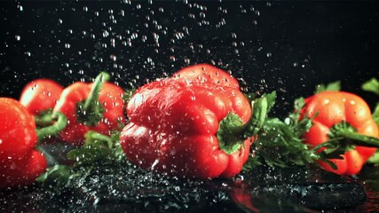 Drops of water with splashes fall on the sweet pepper. On a black background. Filmed is slow motion 1000 fps. - Powered by Adobe