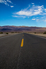 Long desert highway leading into Death Valley National Park