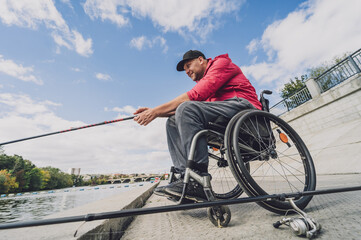 Person with a physical disability who uses wheelchair fishing from fishing pier.