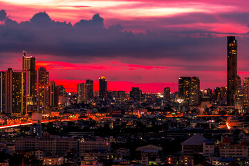 The high angle background of the city view with the secret light of the evening, blurring of night lights, showing the distribution of condominiums, dense homes in the capital community