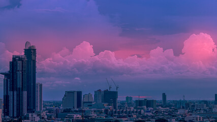 The high angle background of the city view with the secret light of the evening, blurring of night lights, showing the distribution of condominiums, dense homes in the capital community