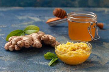 Fresh grated ginger with lemon and honey in a bowl. Healthy condiment and for immunity against covid.