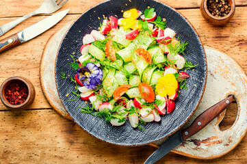 Seasonal vegetable salad on rustic wooden table