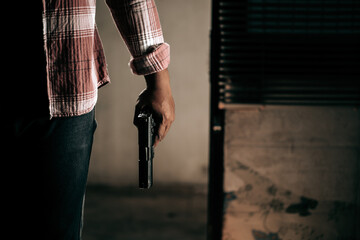 A thief in a striped shirt with a gun breaks through the door of the robber concept.