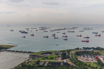 Bird eye of Landscape from bird view of Cargo ships entering one of the busiest ports in the world, over the Garden by the bay in Marina bay sand