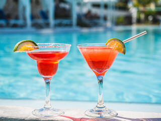 Beautiful glass with a refresh cocktail on the background of the swim pool. Top view, close-up. Vacation and travel concept. Moments of celebration