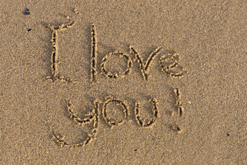 I love you. The inscription is written in the sea sand.