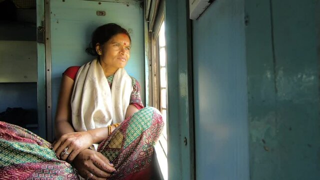 Indian woman traveling in train, India
