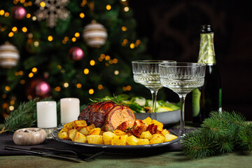 Christmas or New Year dinner table. Baked duck roulade stuffed with meat and oranges, baked potato,...