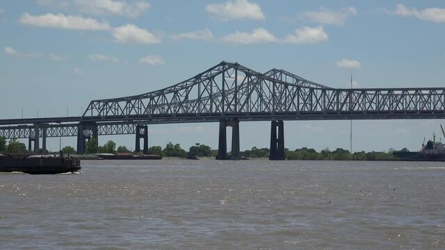 Passenger ferry at  Mississippi river with the Crescent City Connection bridge at background. New Orleans, Louisiana, USA