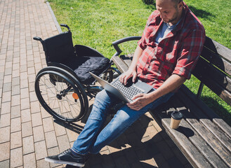 Obraz premium Freelancer with a physical disability who uses wheelchair working at the park