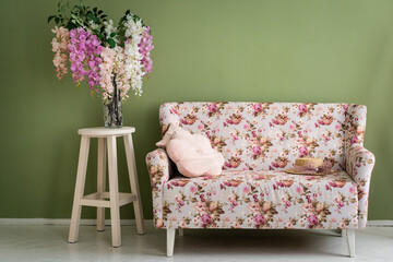 Retro interior. Green wall with Floral sofa and vase on wood floor old vintage retro interior