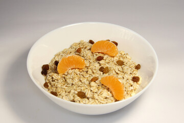 Oatmeal with slices of mandarin and raisins.