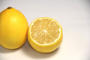 Fototapeta na wymiar Whole and a half lemons. On a white background.