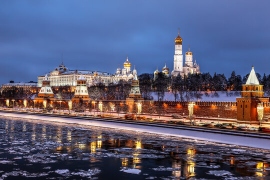View of the Moscow Kremlin, the Kremlin Embankment, the Moskva River with ice floes floating on it on a winter evening. Moscow, Russia