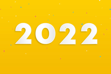 Numbers 2022 on yellow background with colorful confetti for new year concept