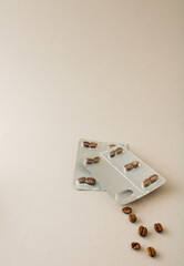 Fototapeta na wymiar Creative coffee shop business background made of real beans and blister pack. Beige summer and winter minimal concept. Unique flat lay.