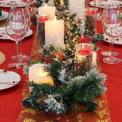 Beautiful table setting with Christmas decorations. Red colors